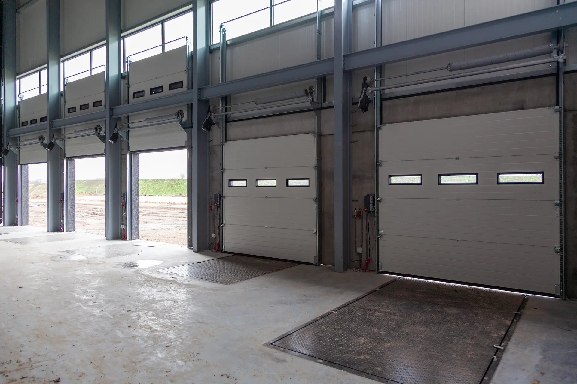 3 open and 2 closed white steel doors