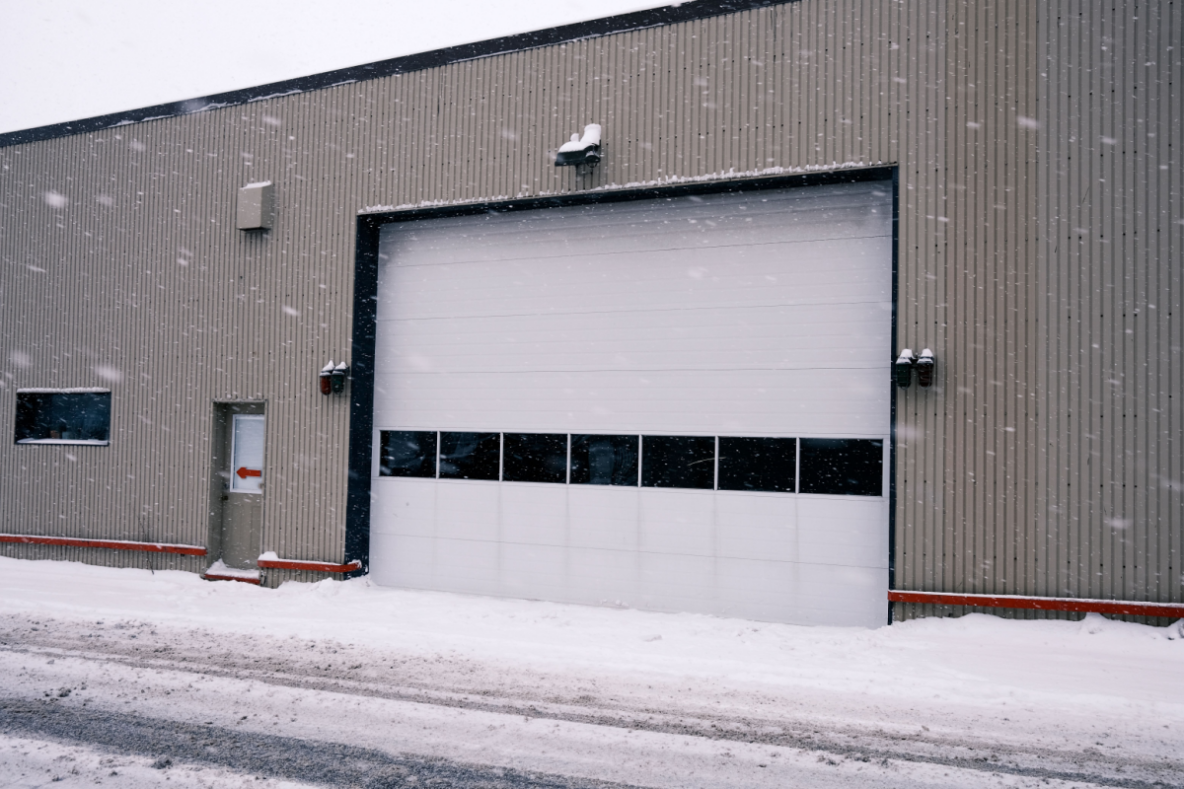 A facility's commercial garage door in the snow